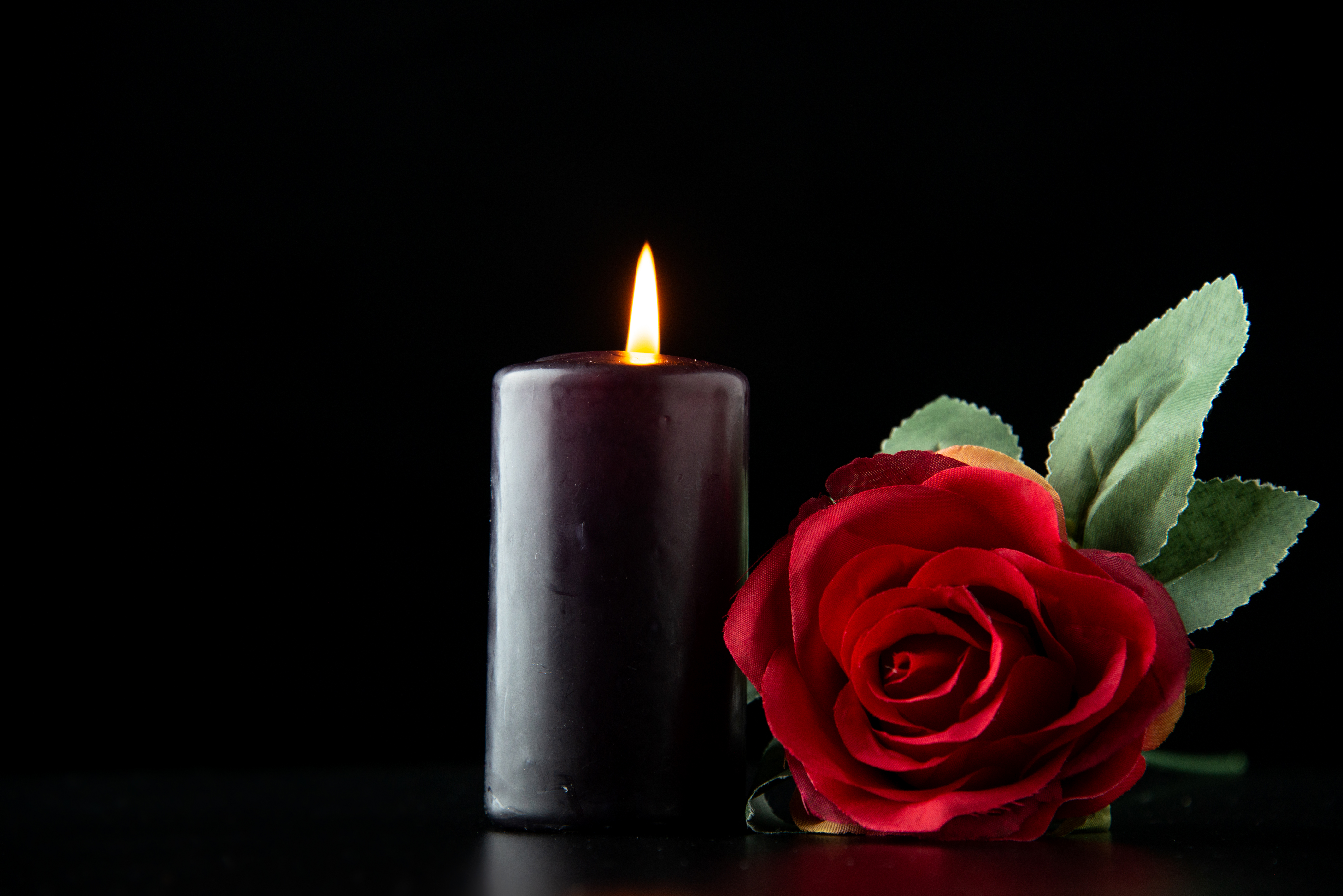 front-view-dark-candle-with-red-rose-dark-surface (1).jpg